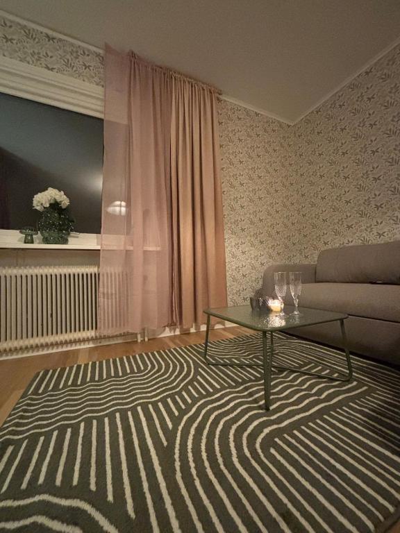 a living room with a couch and a table at Cozy apartment in Åmål