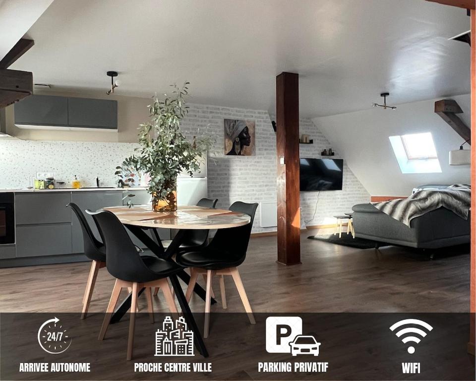 a kitchen and a dining room with a table and chairs at Le Grenier Chic - T3 duplex - Parking privatif in Saint-Omer