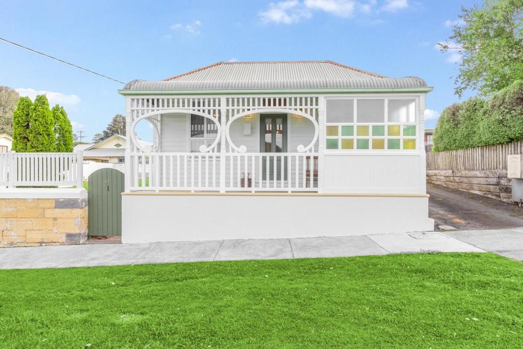 a white house with a gazebo at Koroit Street Cottage in Warrnambool