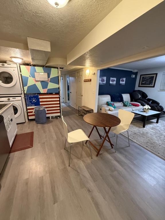 a living room with a table and chairs and a bedroom at Affordable 2-bedroom basement in Clearfield in Clearfield