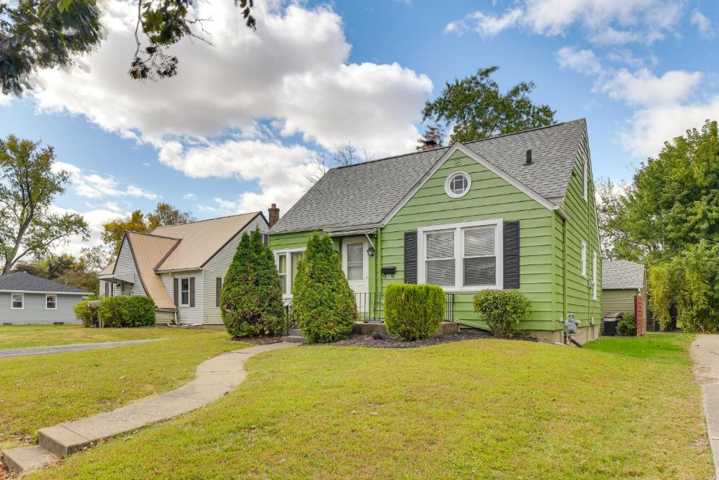 a green house with a gray roof at 1 Mi to Dtwn Burlington Modern Home with Yard! in Burlington