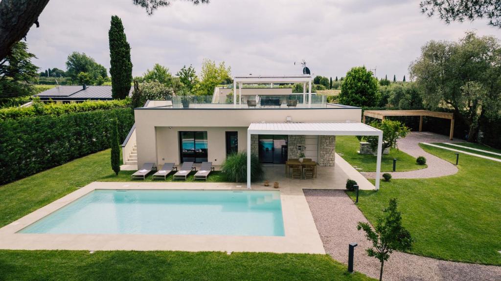 a house with a swimming pool in the yard at Lagolino Boutiquehouse in Pacengo di Lazise