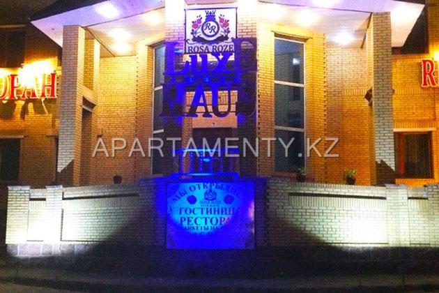 a building with a purple sign in front of it at Rosa Roze Luxe House in Karagandy