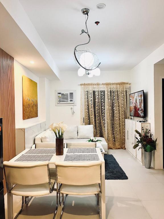a living room with a table and a couch at 2br Unit in Matina Enclaves Davao in Davao City