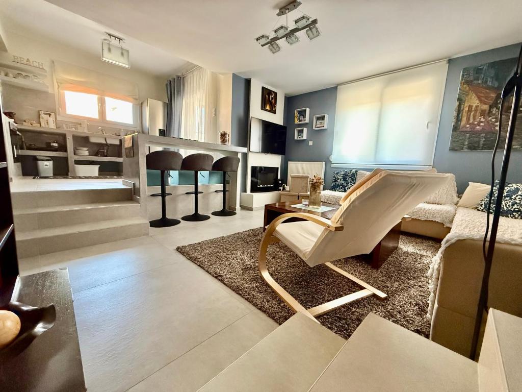 a living room with a couch and a chair at Modern Family Retreat in Volos