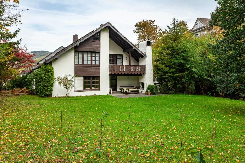 a house with a green lawn in front of it at Azalea in Olsberg