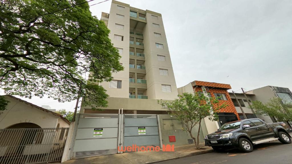 a truck parked in front of a tall building at Apartamento em Bauru no Centro da Cidade in Bauru