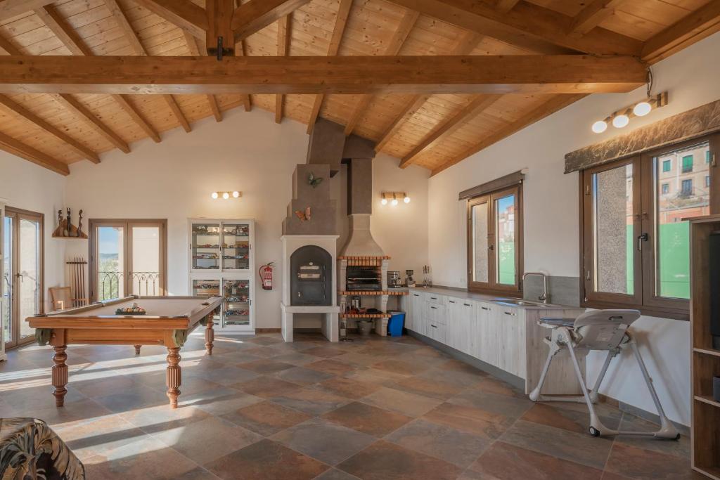 a living room with a pool table and a fireplace at Casa Rural El Rincon Del Che in Castrojeriz