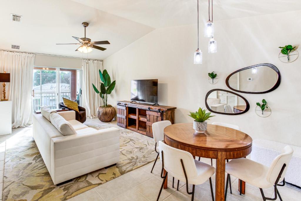 a living room with a table and a couch at Golf Getaway Cape Coral Condo 1 Mi to River! in Cape Coral Hospital Heliport