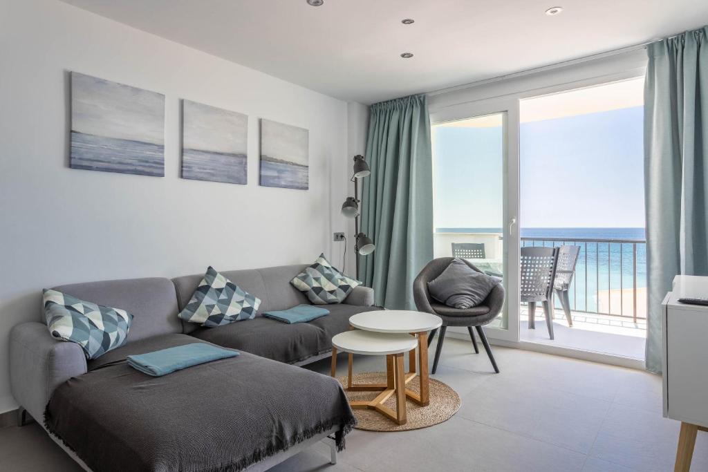 a living room with a couch and a table at Apartment Arce Frontline seaview in Nerja