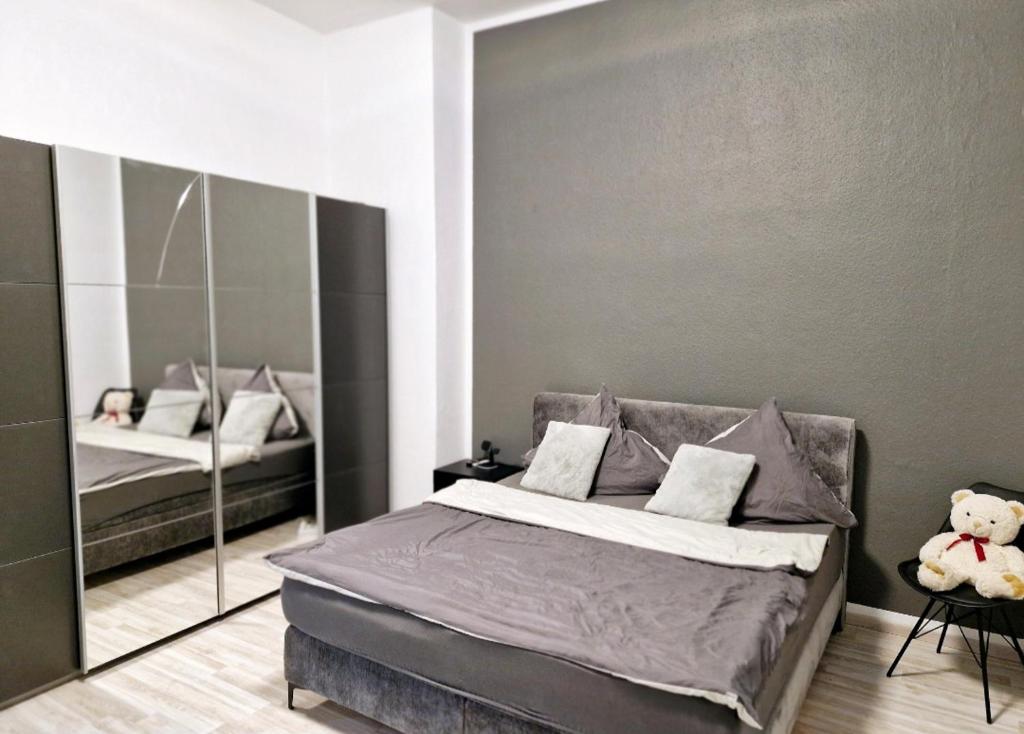 ein Schlafzimmer mit einem großen Bett und einem Spiegel in der Unterkunft CityNest hannover S4 in Hannover