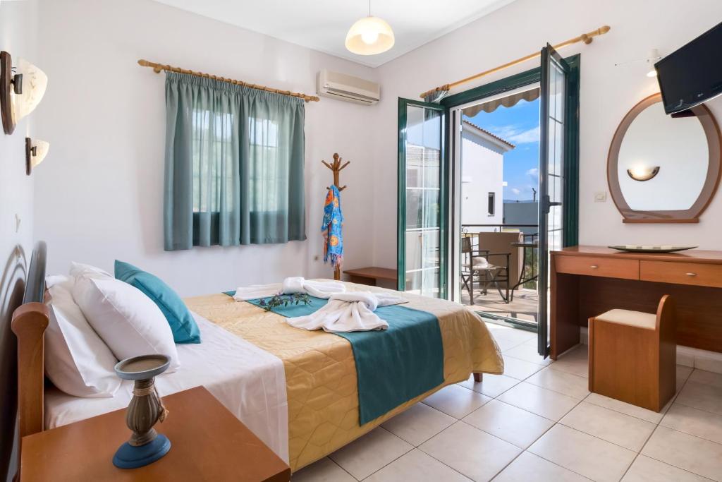 a bedroom with a bed and a mirror at Nikoleta Studio 5 in Nikiana