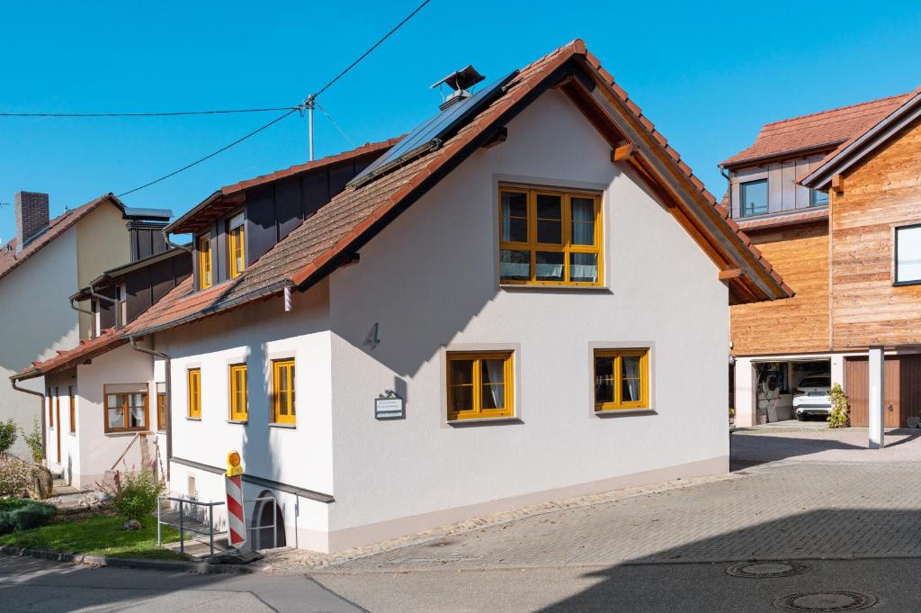 a white house with a brown roof at Ferienwohnung Atelier in Bad Bellingen