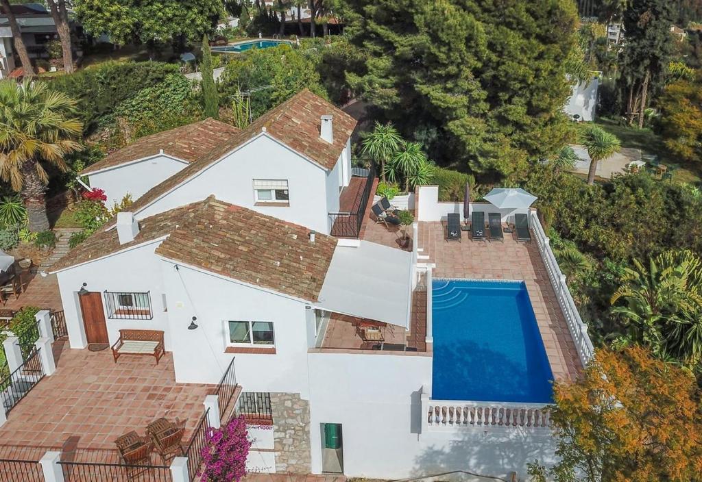 an aerial view of a white house with a swimming pool at Villa, Private pool and great views in Mijas Costa