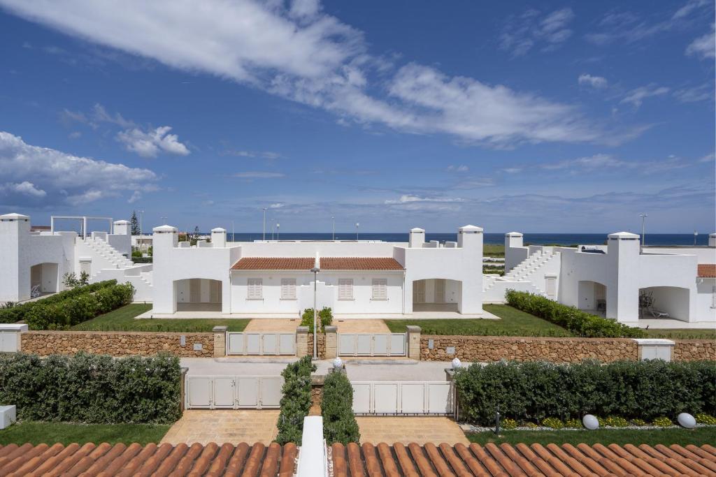a white house with a view of the ocean at Villa Katia - Ostuni in Villanova di Ostuni