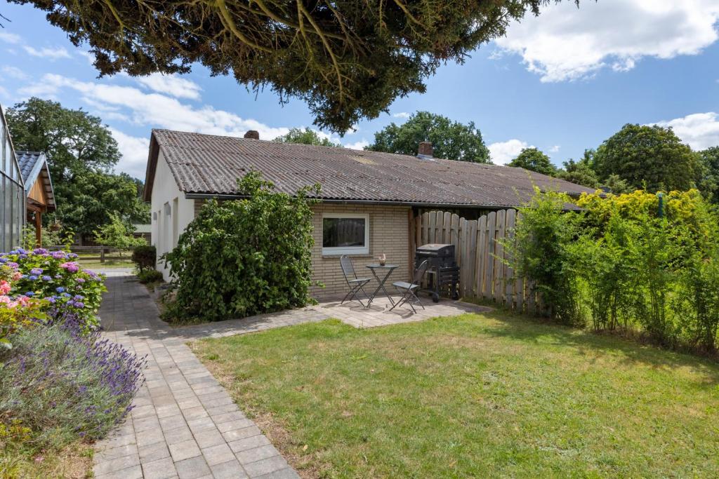 a cottage with a garden and a patio at Ferienwohnung Immenhof in Schwienau