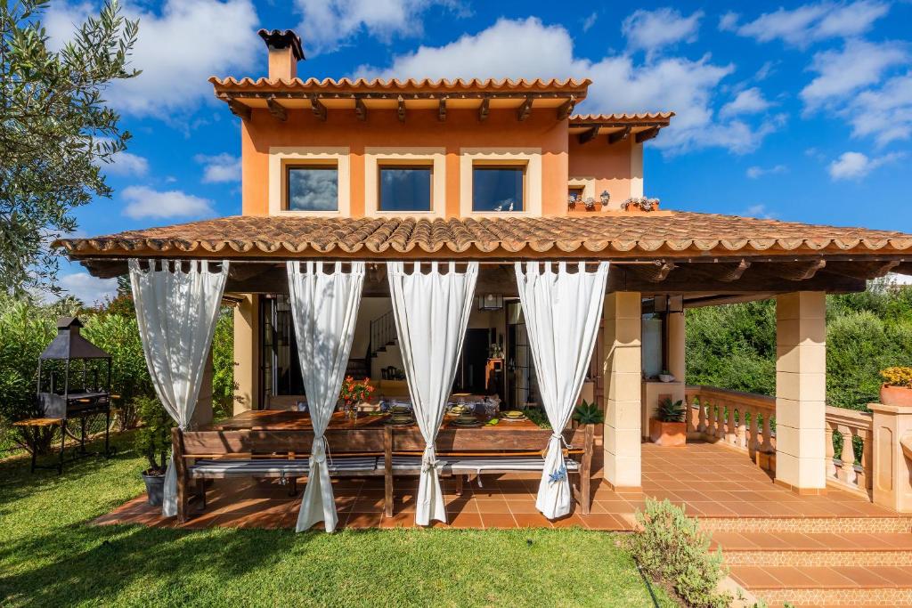 a gazebo in the backyard of a house at Estrella in Son Serra de Marina