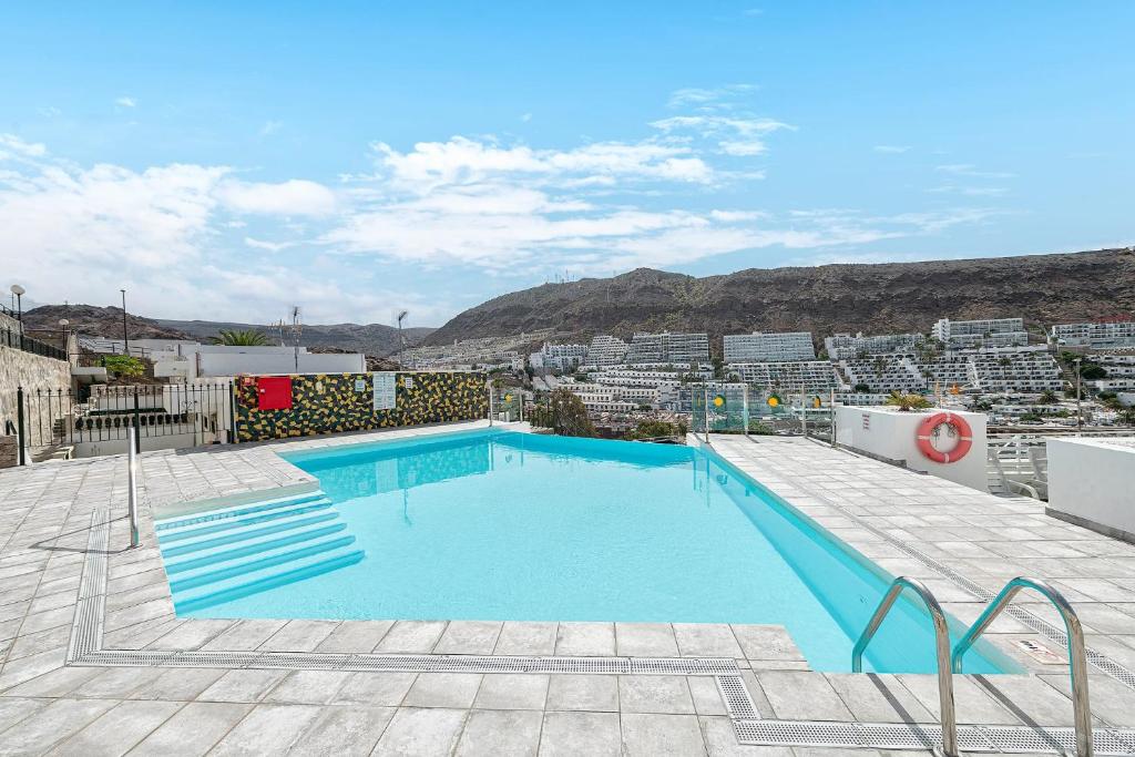 a swimming pool on the roof of a building at Canarian Dream Sun and Peace in Puerto Rico de Gran Canaria