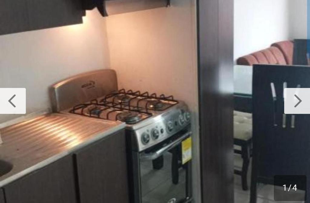 a kitchen with a stove top oven next to a counter at 03 Aires Acondicionados in Cúcuta