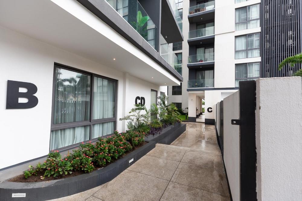 a hallway of a building with plants and flowers at NOVA by BlueWaters Property Management LTD in Accra