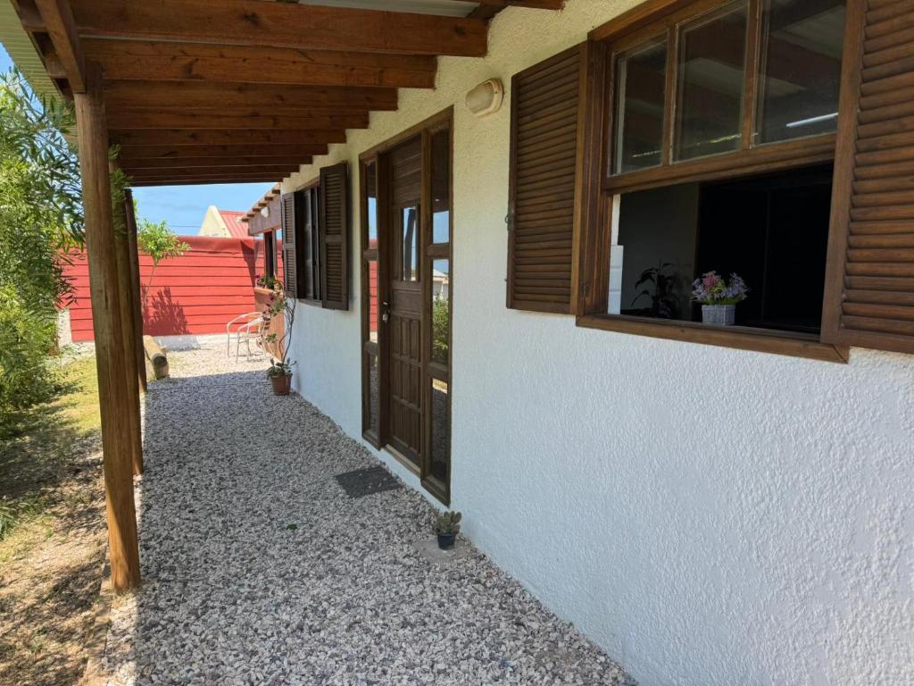 ein Flur eines Hauses mit einer Tür und Fenstern in der Unterkunft Las chochitas 6p in Punta Del Diablo