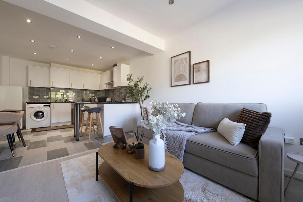 a living room with a couch and a table at Designer 1BR I Work-From-Home Ready I Fast Wi-Fi in Slades Green