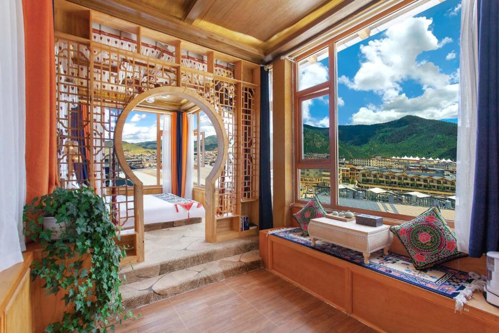 a room with a large window with a view at The Peak Living in Shangri-La