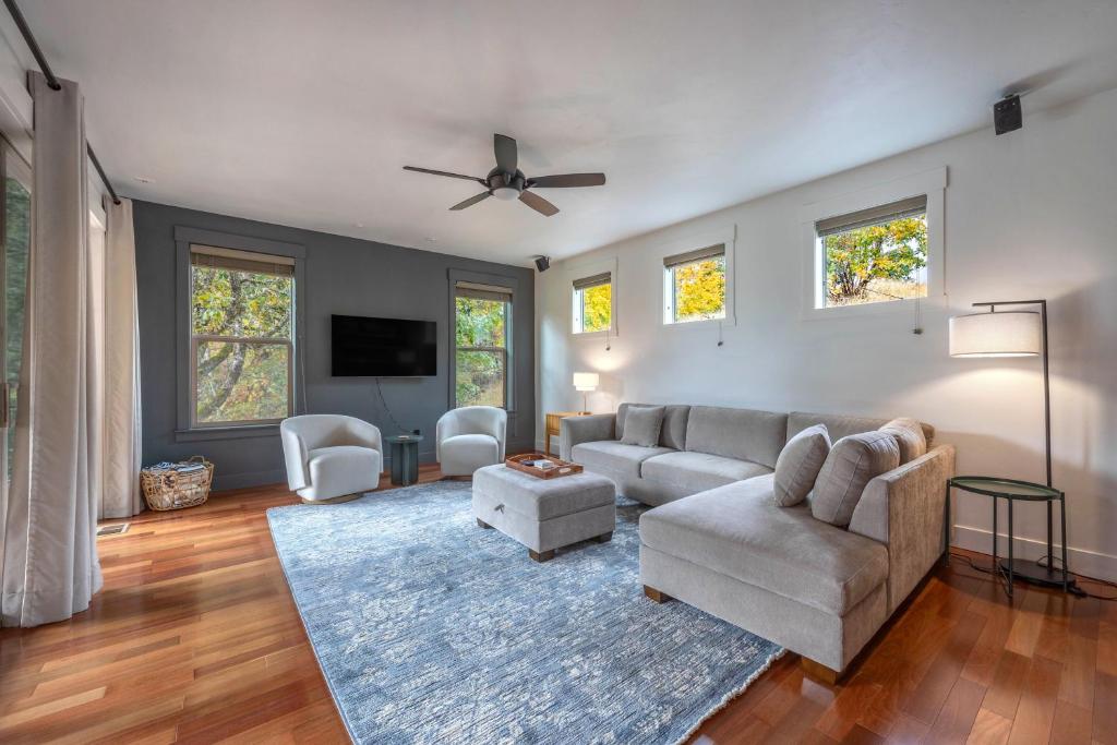 a living room with a couch and a ceiling fan at Evergreen Retreat AB 30 Night Minimum home in White Salmon