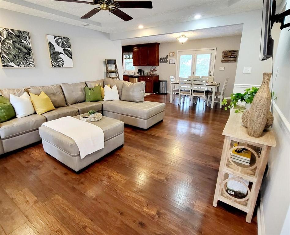 a living room with a couch and a table at Charming Comfy Retreat - Crib, Pet-Friendly, 7 miles to Ft Bragg, Veteran-Owned in Fayetteville