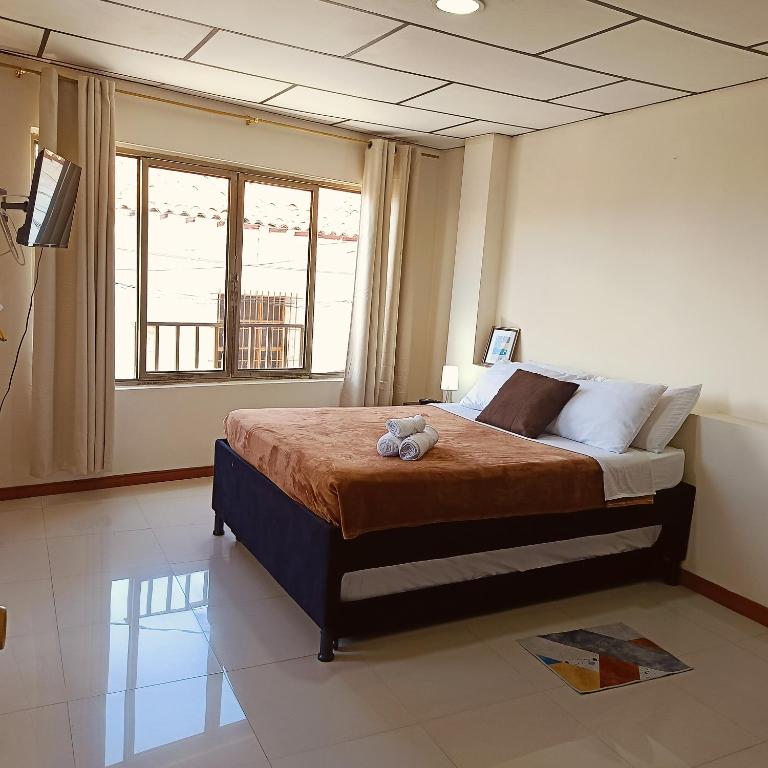 a bedroom with a bed with a teddy bear on it at Apartaestudio central con balcón y wifi en Riosucio in Ruiosucio