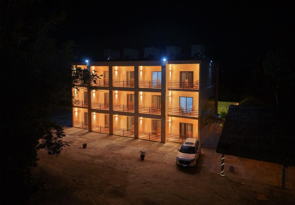 a car parked in front of a building at night at Hotel El Paraíso Calakmul in Xpujil