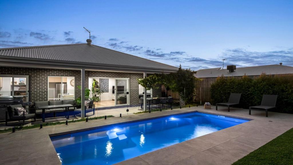 a swimming pool in the backyard of a house at Regal Retreat in Saint Leonards