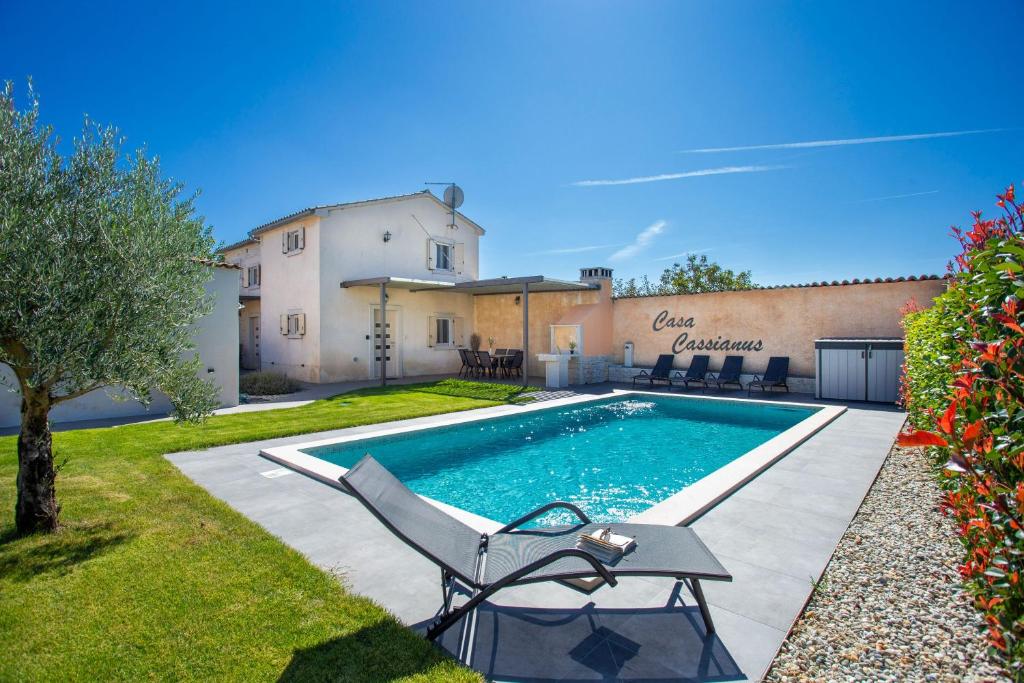 a swimming pool with a chair in a yard at Casa Cassianus - Happy Rentals in Sveti Petar u Šumi