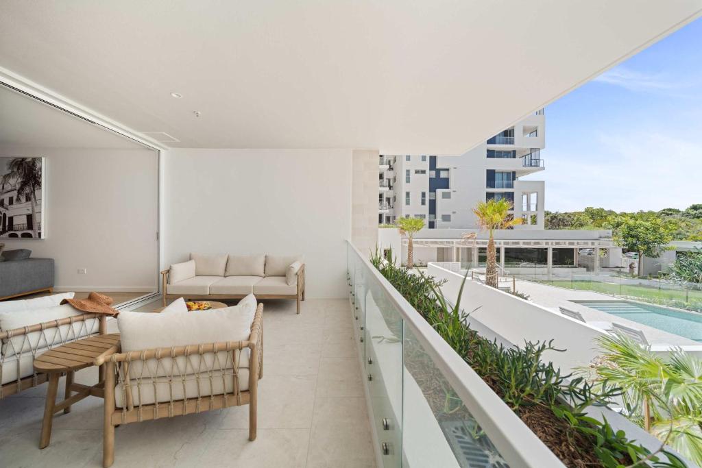 an apartment balcony with a view of a pool at Casa Oasis Beachfront at Bokarina in Bokarina