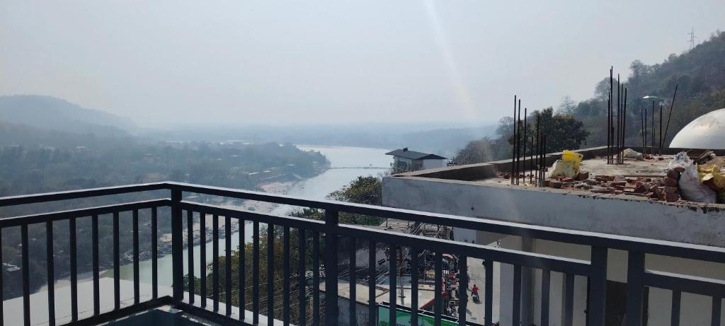 a balcony with a view of a river at Hotel shivansh Residency in Rishīkesh