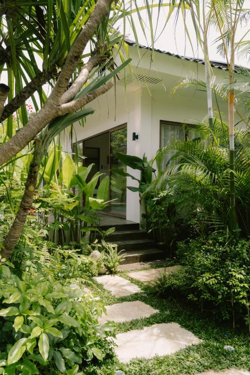 a walkway leading to the front of a house at Ananda House in El Nido