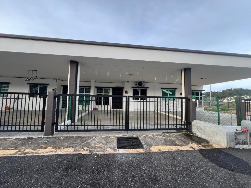 a building with a gate in front of it at Hasya Guesthouse in Seri Iskandar