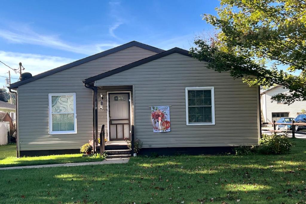 a gray house with a door in a yard at Sir Happy's Place in Elkins