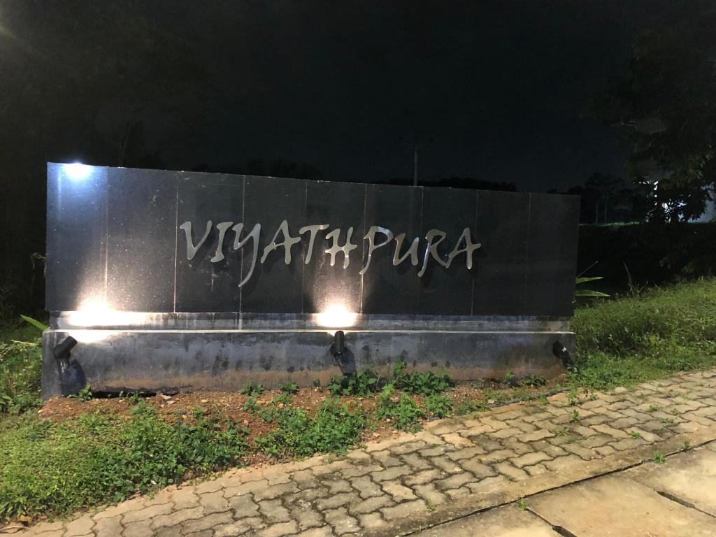 a wall with graffiti on it at night at Viyathpura in Nikawatawana