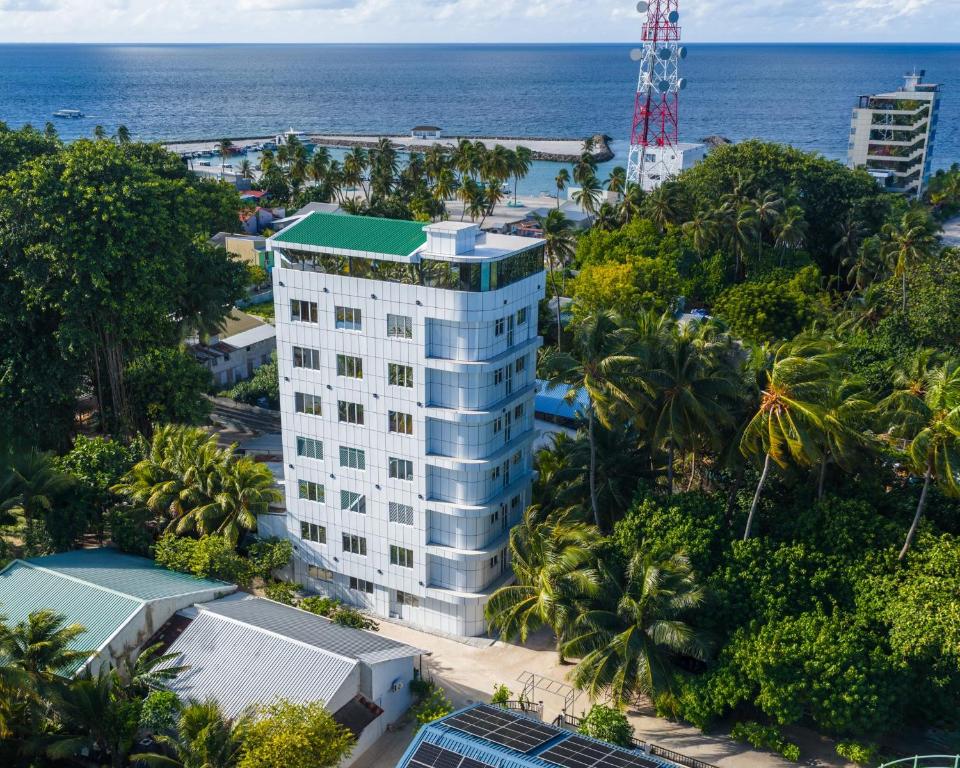 an aerial view of a building in front of the ocean at Nest by Hawks Hotels Kamadhoo Baa Atoll in Kamadhoo