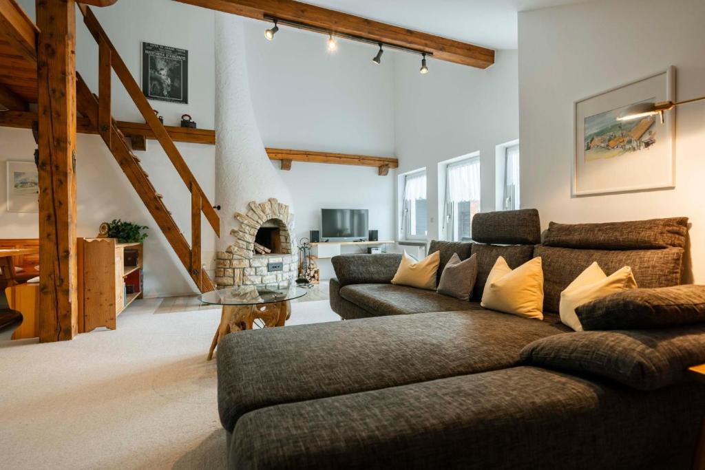 a living room with a couch and a fireplace at Haus Gerlinde in Drachselsried