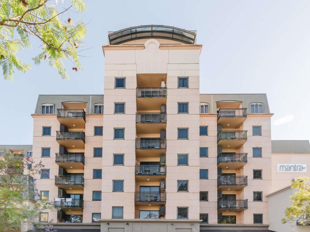 an apartment building with balconies on it at Mantra on Hay Perth in Perth