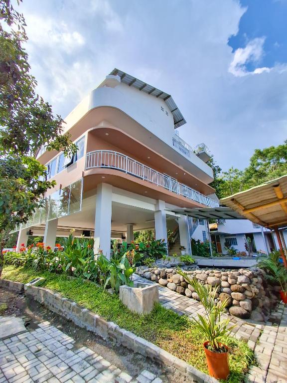 a large building with a lot of plants in front of it at Hotel Kebon Kana Kaliurang in Kaliurang