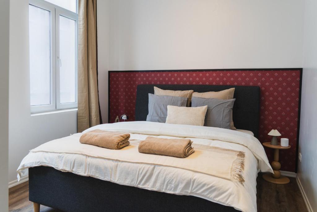 a bedroom with a large bed with two pillows on it at Lovely 1BR & 1LR Apartment, Only 15 Min Walk to City Center in Ghent