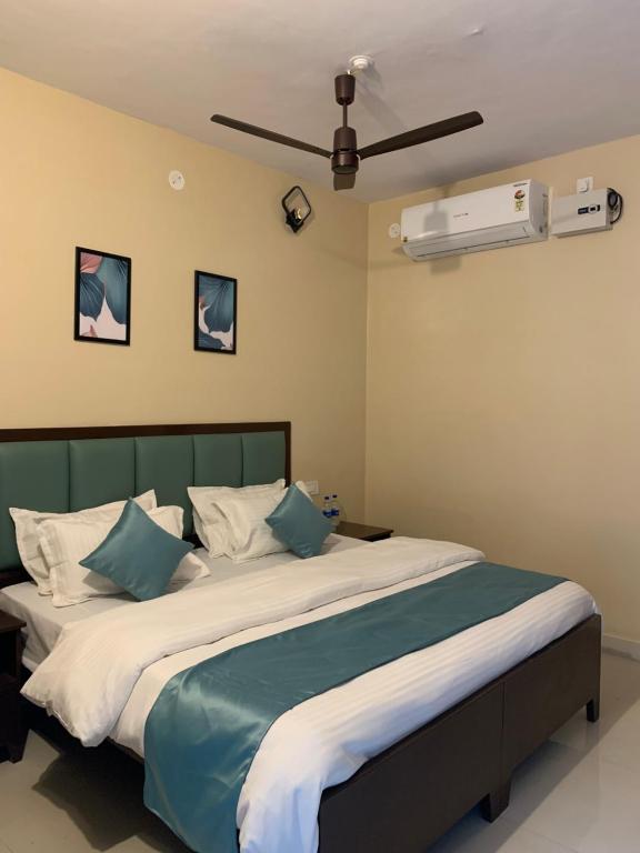 a bedroom with a large bed with blue and white pillows at Banyan Tree Resort in Ranakpur