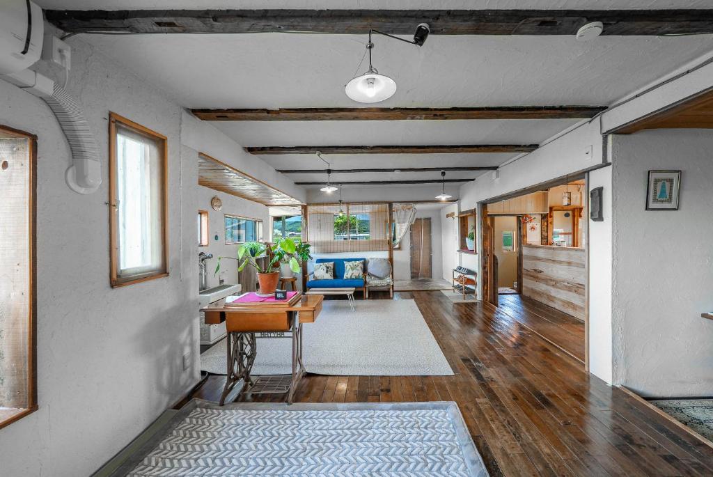 a living room with a table and a dining room at Peace Garden Furano in Nakafurano