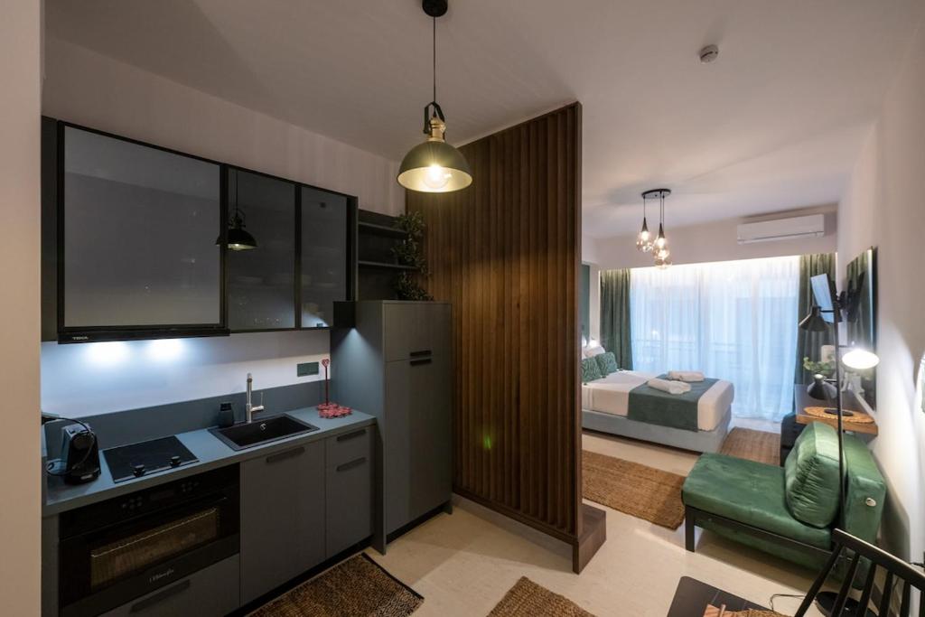 a kitchen with a sink and a living room at Urban Nest in Kalamata