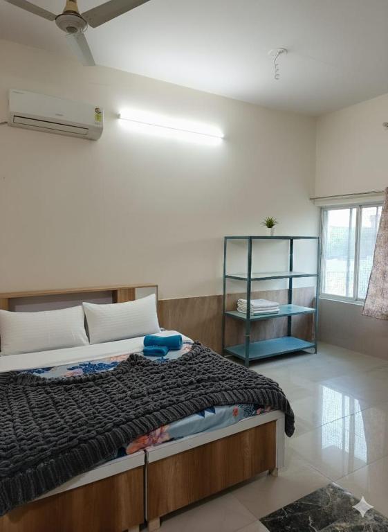 a bedroom with a large bed in a room at Hotel Sukhdev in Nawalgarh