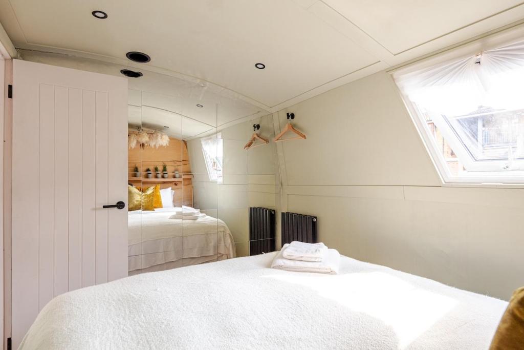 a bedroom with two beds and a window at The Floating Terrarium in London