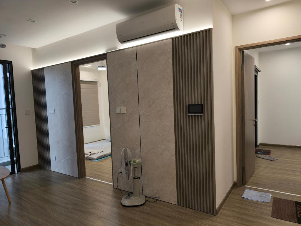 a room with a glass door with a heater on the wall at Luxhomes Sa1 Toji Sakura Smart city in Phú Thú